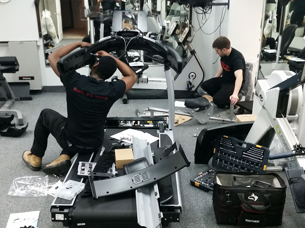 Staff assembling commercial fitness equipment