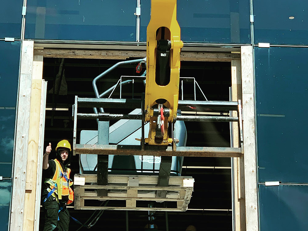 Staff transporting commercial stairmaster from fitness facility